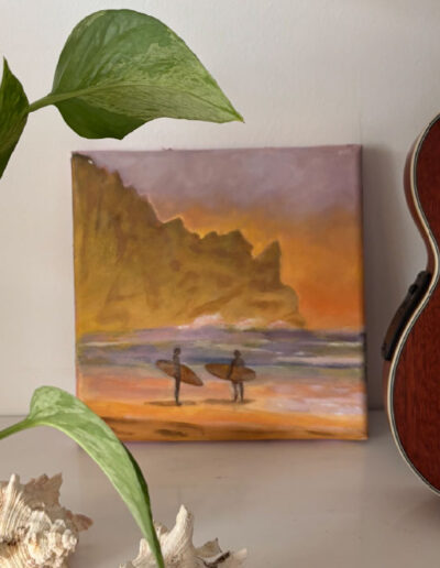 Un tableau représentant des surfeurs, aux couleurs du coucher de soleil